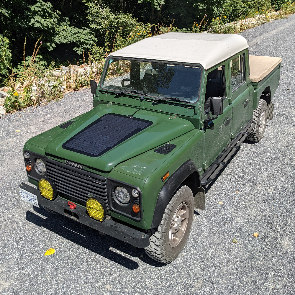 The cascadia 4x4 VSS system hood solar panel kit for the land rover defender 1983-2006. Shown here on a green 130 pickup