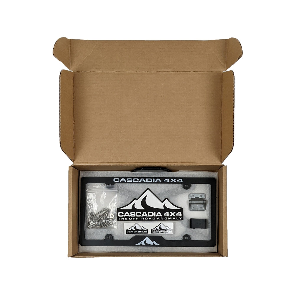 The Cascadia 4x4 Flipster V3 winch license plate mounting system showing the packaging box open with parts inside. 